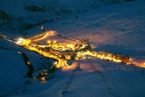 帕斯底拉卡萨伊莫德尔帕斯戈力兹里公寓的享有滑雪胜地的夜间景色