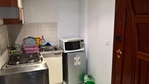 突尼斯哥扎娜公寓的厨房配有冰箱上方的微波炉