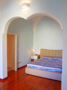 莱韦拉诺Casa Donna Rita的一间卧室,配有一张位于上面的拱门的床