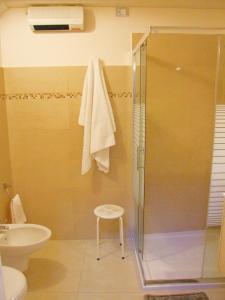 莱韦拉诺Casa Donna Rita的带淋浴、凳子和水槽的浴室