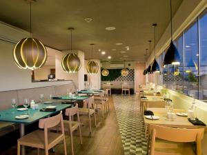 圣地亚哥圣地亚哥机场城市快捷酒店的用餐室配有桌椅和灯光