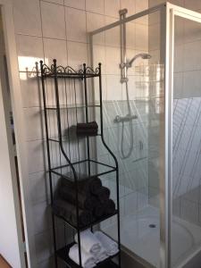 蒂尔堡Gastenverblijf Door de Poort的带淋浴的浴室内的毛巾架