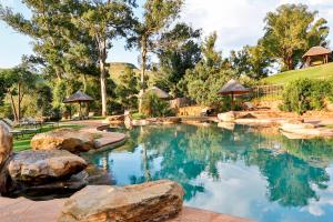 Bonjaneni曼秋斯山旅馆的后院的游泳池,有岩石和树木