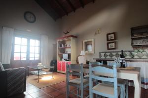 莫卡诺尔Casa Rural la Hojalata的一间带桌子的客厅和一间餐厅