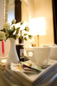 科尔菲奥里托日拉斯福蒂酒店的一张带白色花瓶和花瓶的桌子