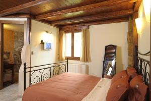LefkimmiApolithomeno Dasos Holiday Villas的一间卧室设有一张带木制天花板的大床