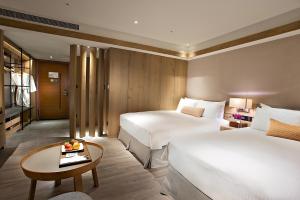 Wenquan知本老爷酒店的酒店客房设有两张床和一张桌子。