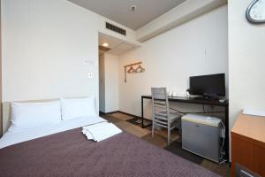 宇都宫宇都宫酒店的客房设有一张床、一张桌子和一台电脑