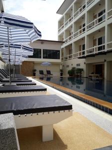 哈林海滩帕岸岛明珠别墅酒店的庭院内带遮阳伞的酒店游泳池
