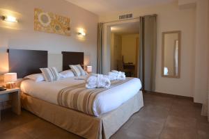 博尼法乔阿马多内塔酒店的酒店客房带一张大床,带毛巾