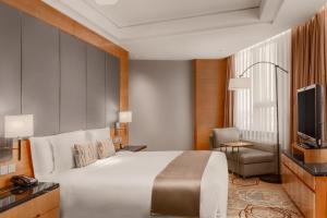 嘉定上海颖奕皇冠假日酒店 - 距离F1赛车场15分钟车程的酒店客房,配有床和电视