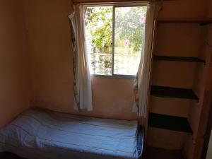 阿加斯杜尔斯Los Lachos的一间小卧室,配有床和窗户