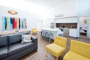 LoxtonLoxton Courthouse Apartments的带沙发和椅子的客厅以及厨房。