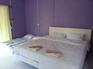 库德岛阁骨岛班普恩旅馆的一间卧室配有两张带白色床单和枕头的床。