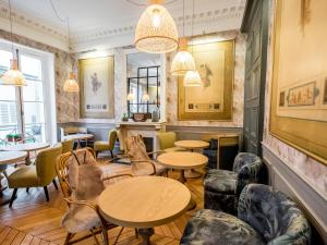 巴黎1er Etage SoPi-Montmartre的餐厅设有桌椅和窗户。