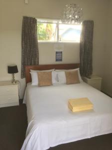 奥雷瓦奥雷瓦枕头旅舍的卧室配有白色的床和木箱