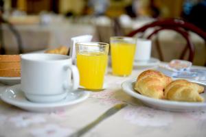 伊瓜苏港莉莲酒店的一张桌子,上面放着一盘面包和橙汁