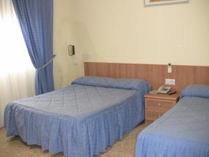 洛斯赫马纳斯酒店 客房内的一张或多张床位
