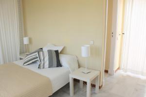 圣玛丽亚港波多黎各雪利公寓式酒店的一间卧室配有一张床和一张带台灯的桌子
