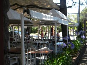 圣特雷西塔Parque Hotel的室外餐厅设有桌椅和遮阳伞。