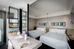 台南长悦旅栈的酒店客房设有两张床和盥洗盆