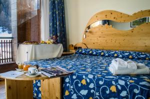 巴多尼奇亚瑞维酒店 - 康普里所图里斯提科坎普史密斯的一间卧室配有一张带木制床头板和一张桌子的床。