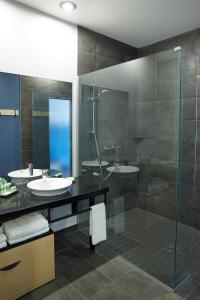 蒙特利尔乐多芬蒙特利尔中心维莱酒店的一间带玻璃淋浴和水槽的浴室