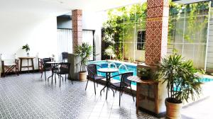 卡马拉海滩The Umbrella House - SHA Extra Plus的餐厅内带桌椅的庭院