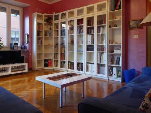 都灵Casa Clemente in Cit Turin的客厅配有咖啡桌和书柜