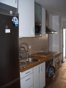圣玛丽亚港Apartamento Caballo Sherry的厨房配有水槽和黑冰箱。