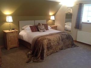康廷Lochview Guesthouse的一间卧室配有一张大床和两盏灯。