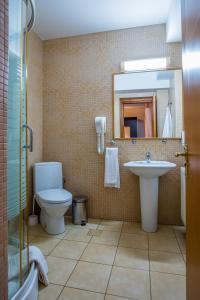 勒德乌齐Hotel Maria的一间带卫生间、水槽和镜子的浴室