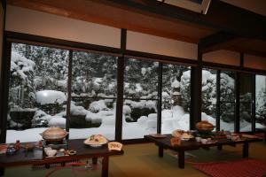京都汤温泉奥哈拉山水酒店的一间窗户外的雪饭厅