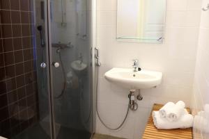Oravi奥拉维公寓酒店的带淋浴和盥洗盆的浴室