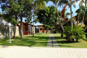 乌巴图巴Suites Grande Tenorio的棕榈树庭院和建筑