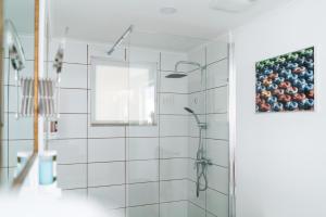 棕榈滩Cas Elizabeth的浴室铺有白色瓷砖,设有淋浴。