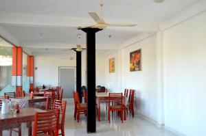 平纳瓦拉Cafe Pinnalanda的一间带桌椅和吊扇的用餐室
