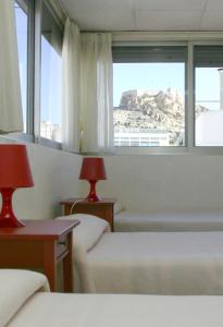 阿利坎特塞万提斯酒店的酒店客房设有两张床和窗户。