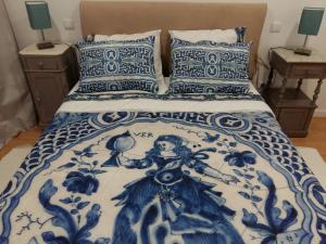 维拉·普拉亚·德·安科拉Hostel D'Avenida的一张带蓝色和白色棉被和枕头的床