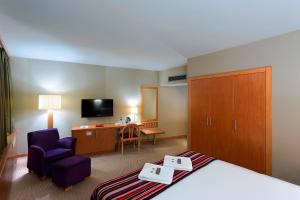 伯萨肯特酒店 的酒店客房配有一张床、一把椅子和一张书桌