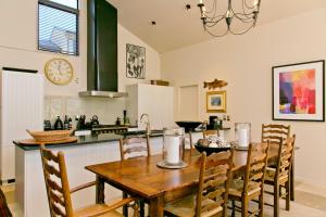 陶波柏银特别墅酒店的厨房以及带木桌和椅子的用餐室。
