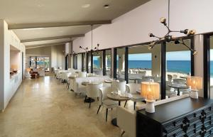 卡波圣卢卡斯Paradisus Los Cabos - Adults Only - All Inclusive的一间设有桌椅的海洋餐厅