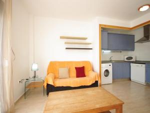 塔里法Livingtarifa Apartamento Blue II的客厅配有橙色椅子和桌子
