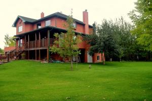 WainwrightSouth Africa House Guest Lodge的一个大红色房子,有大院子