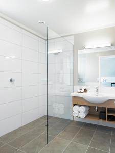 汉密尔顿银色汽车旅馆的一间带玻璃淋浴和水槽的浴室