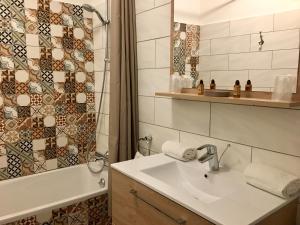 阿维尼翁马南酒店的浴室配有水槽、淋浴和浴缸。