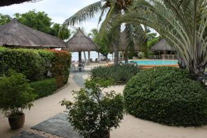 邦劳丽娜海滩度假村的一座带游泳池、树木和灌木的度假村
