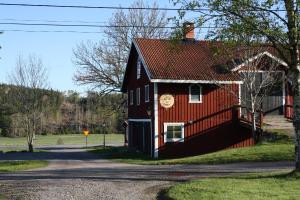 EnhörnaLadugårdens Pub & Sal的一面漆着脸的红色谷仓
