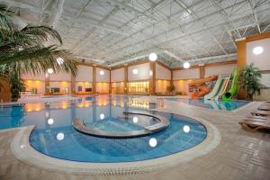 Gazligol厄兹居尔大热度假酒店的一座带滑梯的大型室内游泳池