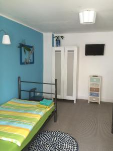 不莱梅Apartmenthaus Kornstrasse的一间卧室设有一张床和蓝色的墙壁